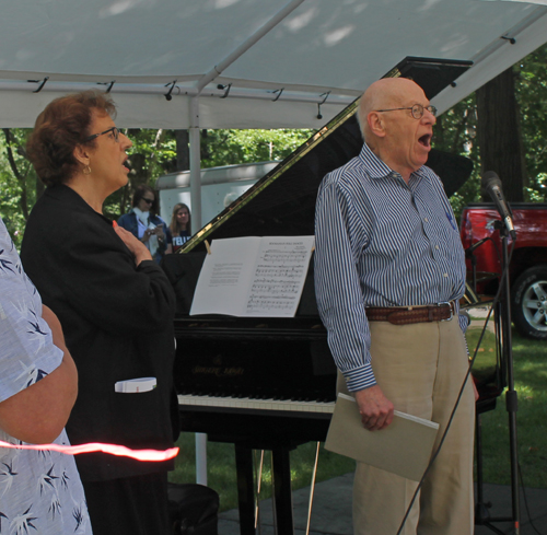 Carolyn Balogh and Ted Horvath sing the anthem