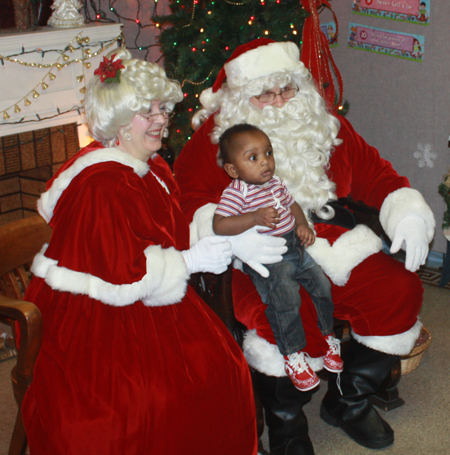 Santa Claus and Mrs Claus and little girl