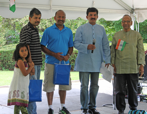 Babu and Ganesh Iyer accepting prizes on behalf of Srikrishnaprasad Muvva and Chetak Chakravar, the winners of the doubles tournament