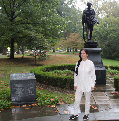 Posing with the statue of Gandhi