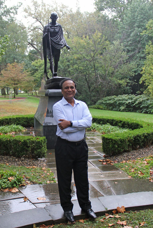 Posing with the statue of Gandhi