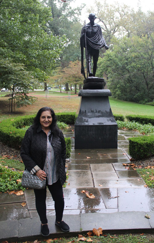 Posing with the statue of Gandhi