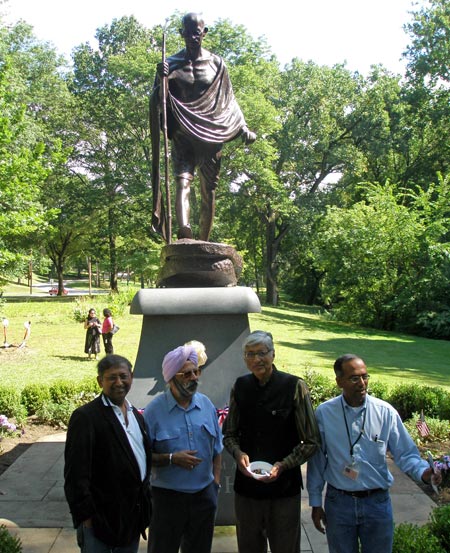 Rajmohan Gandhi and Raj Aggarwal  pose in front of the Mahtama Gandhi statue in Cleveland Indian Cultural Gardens
