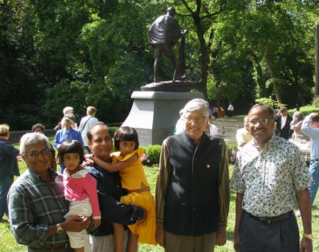 Rajmohan Gandhi and wife Usha pose in front of the Mahtama Gandhi statue in Cleveland Indian Cultural Gardens