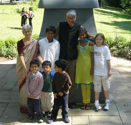 Rajmohan Gandhi and wife Usha pose in front of the Mahtama Gandhi statue in Cleveland Indian Cultural Gardens