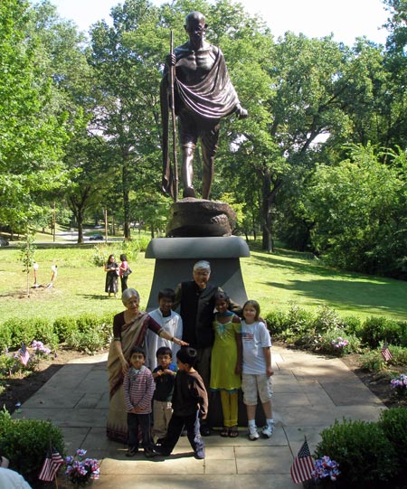 Rajmohan Gandhi and wife Usha pose in front of the Mahtama Gandhi statue in Cleveland Indian Cultural Gardens