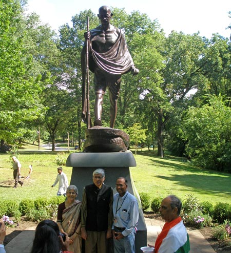 Rajmohan Gandhi and wife Usha pose in front of the Mahtama Gandhi statue in Cleveland Indian Cultural Gardens