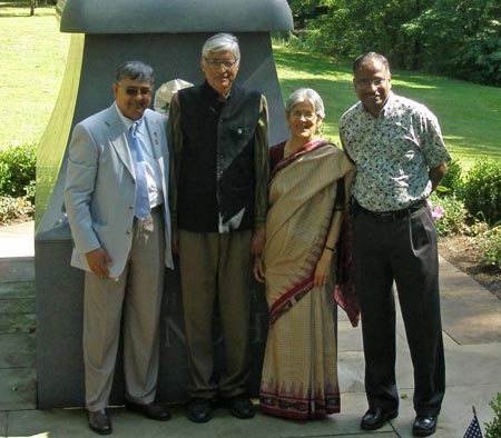 Rajmohan Gandhi and wife Usha pose in front of the Mahtama Gandhi statue in Cleveland Indian Cultural Gardens