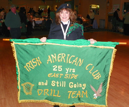 Janet Smrdel with Drill Team banner