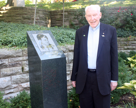 Father Jim O'Donnell in front of Brendan Behan monument