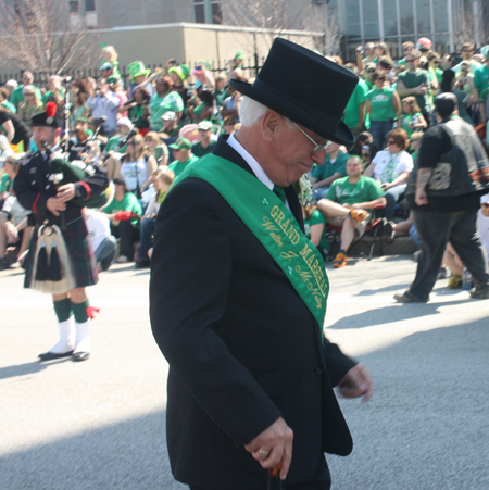 Grand Marshall Mickey McNally marching through the Cleveland Firefighters Memorial Pipes & Drums lines