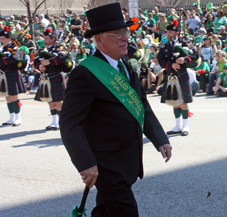 Grand Marshall Mickey McNally marching through the Cleveland Firefighters Memorial Pipes & Drums lines