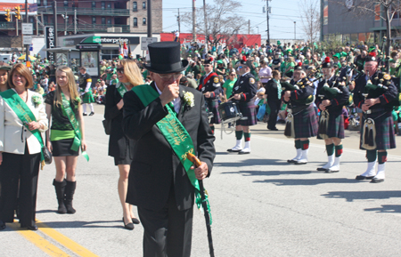 Grand Marshall Mickey McNally marching through the Cleveland Firefighters Memorial Pipes & Drums lines