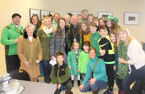 Family posing with Bishop Nelson Perez