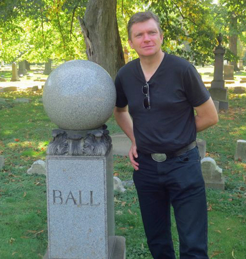 Singer James Kilbane stands by gravestone of Ernest Ball in Lakeview Cemetery in Cleveland Ohio.