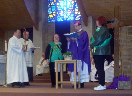 Bishop Richard G. Lennon blesses shamrocks, gives them to Debbie Hanson who gives them to Woman of the Year Linda Burke 