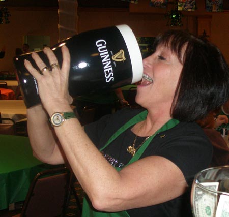 Kathy Kintz jokes with a large Guinness