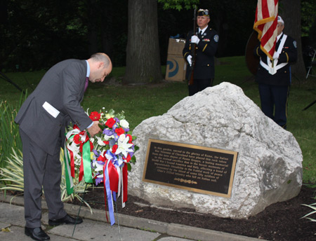 Italian Consul Marco Nobili places a wreath