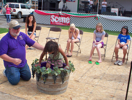 Young girl stomping grapes