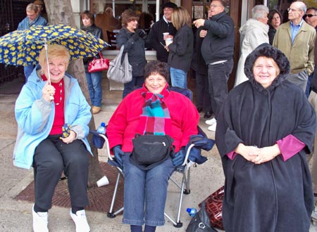 Italian ladies watch parade in rain