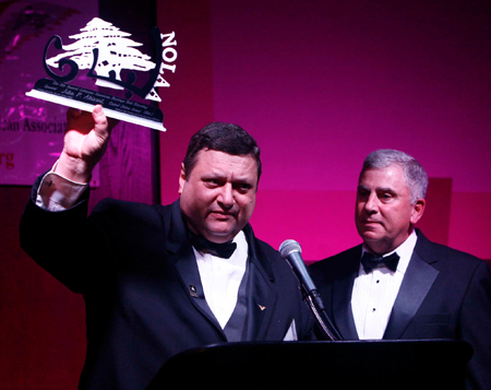 Pierre Bejjani shows the Cedar Tree award to General Abizaid