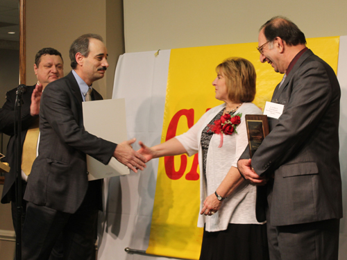 Mayor Richard Dell'Aquila preents plaque to Elinor Boujaily's daughter and son