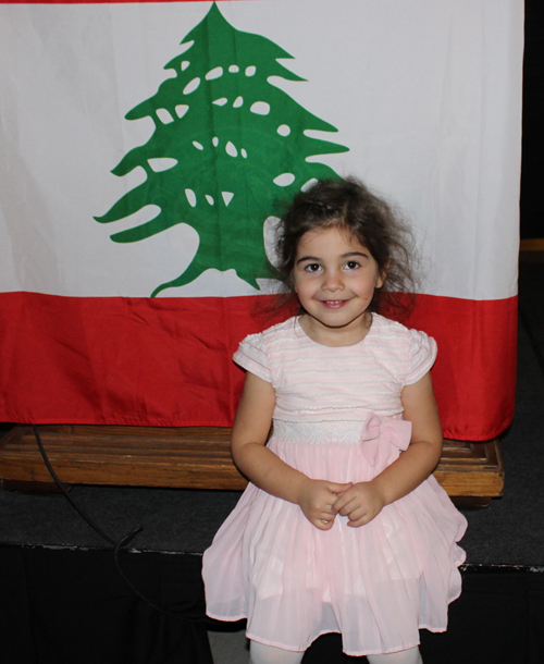 Little Girl Posing in front of the flag of Lebanon