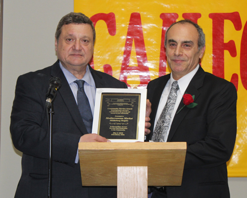 Pierre Bejjani awards the Mediterranean Market's Gus Karim