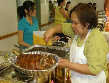 Serving lechon (pork) at Filipino festival