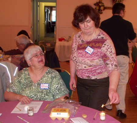 Ann Greczank and Cindy Plizga  prparing to apply melted beeswax