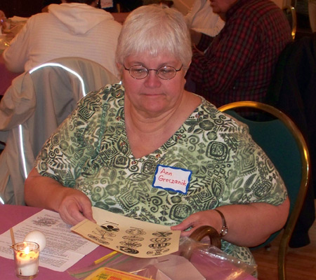 Ann Greczank studies some of the egg designs