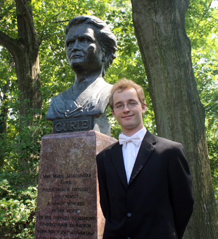 Musician Konrad Binienda in front of Madame Curie bust
