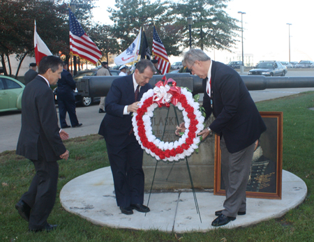 Dennis Kucinich, Joseph A. Drobot, Jr. and Michael Polichuk place the wreath at the Pulaski cannon