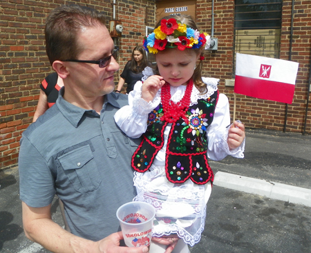 Man with daughter in Polish costume