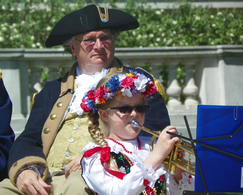 young girl plays trumpet