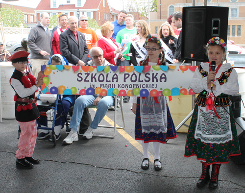 A young girl in traditional Polish costume from a Polish School, Szkola Polska,  recited a poem in Polish