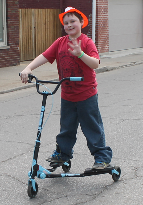 Boy on scooter at Polish Constitution Day Parade in Slavic Village in Cleveland