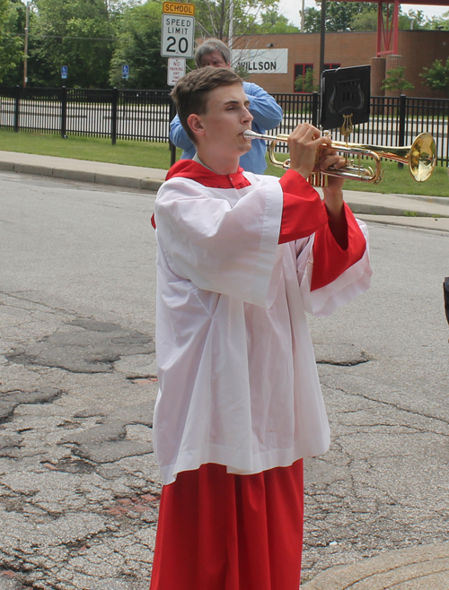 Altar boy plays Hejnal on trumpet