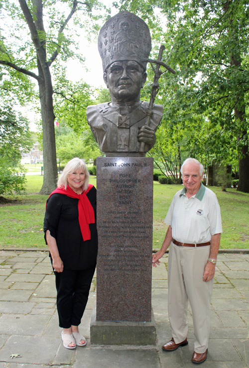 Connie Adams and Gene Bak with Posing with the newly installed bust of Saint John Paul II