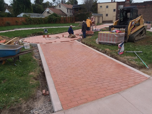 Laying bricks in new Polish Heritage Garden in Cleveland