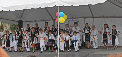 Young boys and girls in traditional Romanian costumes danced to a Romanian song 
