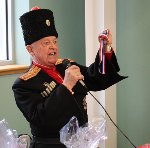 Blini Contest judge Ken Kovach presenting a medal