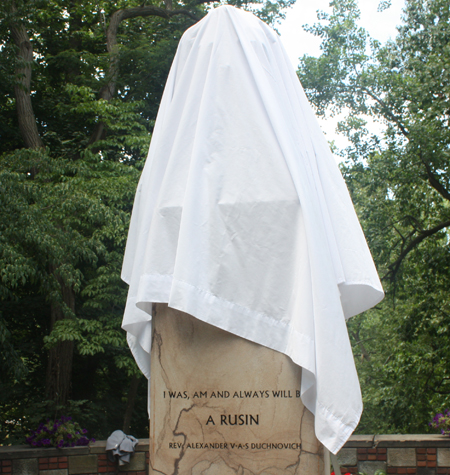 Bust of Aleksander Duchnovic covered with sheet in the Rusyn Garden in Cleveland