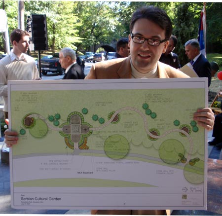 Alex Strmac holding map of Serbian garden