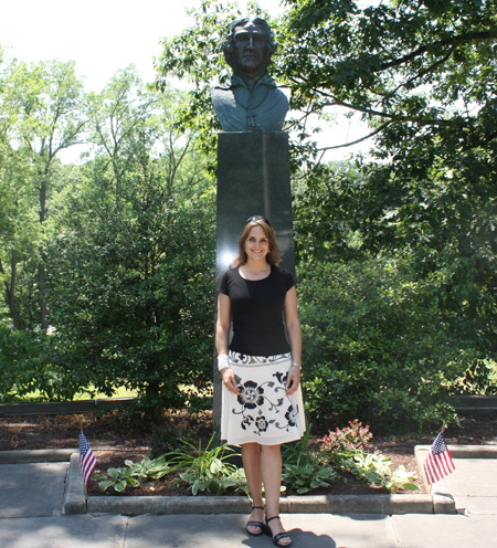 Johanna Bajc in front of the Bishop Baraga bust