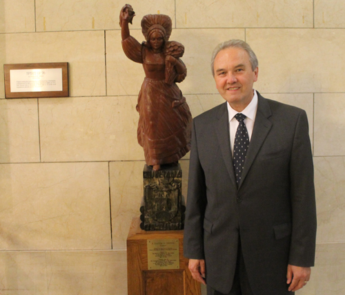 Slovenian Ambassador to US Roman Kirn with the statue in June 2013