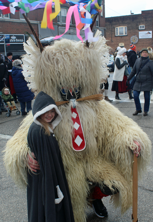 Kurent with little girl at Kurentovanje