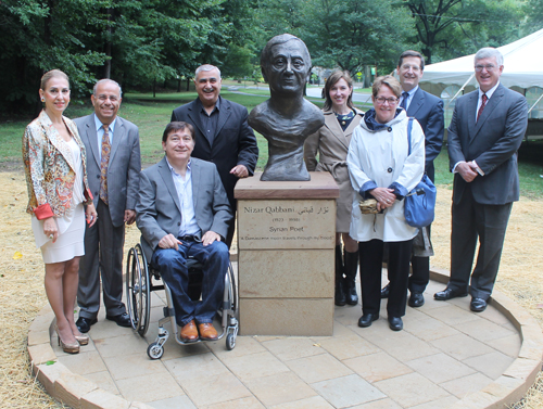 Posing with the statue of the Syrian poet Nizar Qabbani in the Syrian Cultural Garden in Cleveland