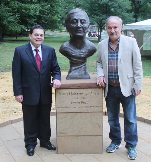 Posing with the statue of the Syrian poet Nizar Qabbani in the Syrian Cultural Garden in Cleveland