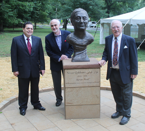 Posing with the statue of the Syrian poet Nizar Qabbani in the Syrian Cultural Garden in Cleveland